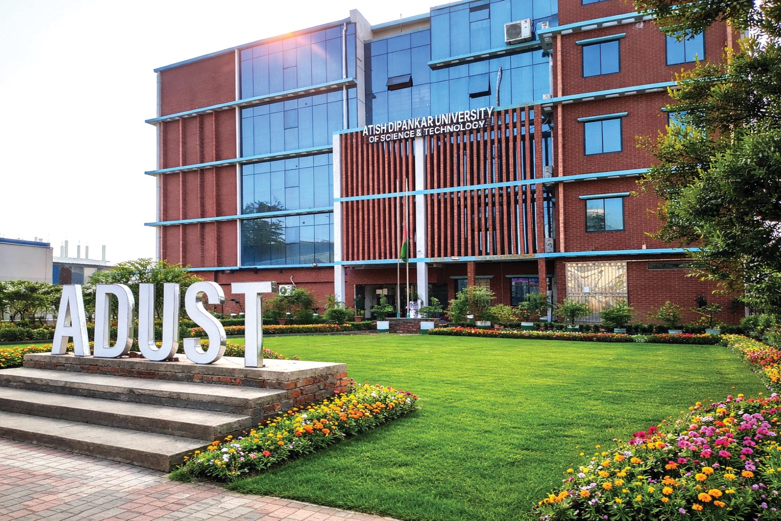 Atish Dipankar University of Science and Technology (ADUST) campus building and the ADUST sign